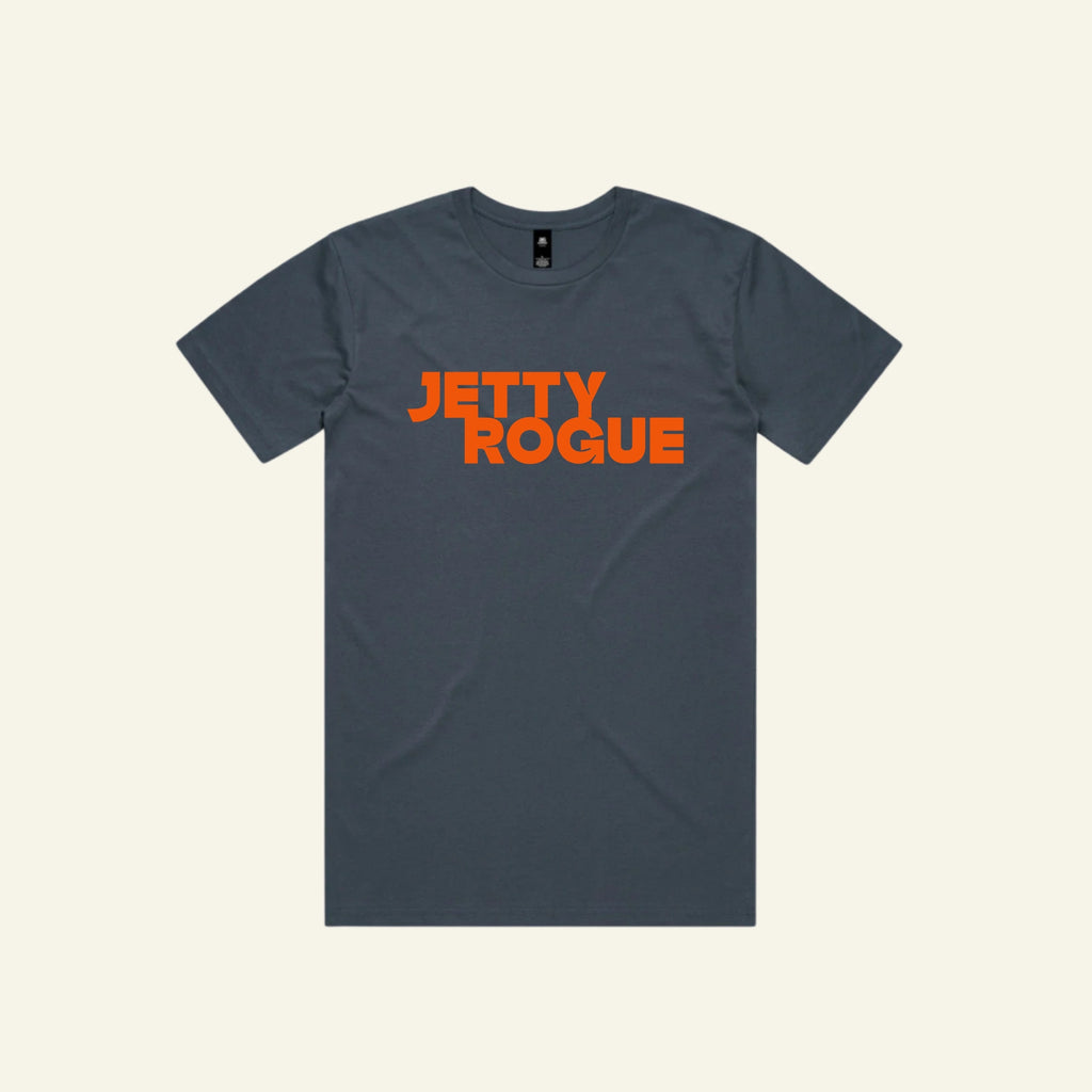 Petrol blue tee flat lay: Jetty Rogue unisex tee in petrol blue with burnt orange logo, flat lay