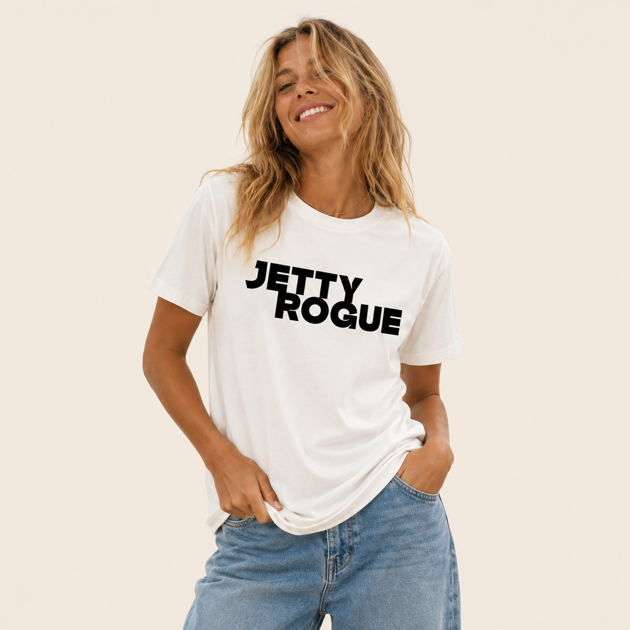 Bone tee on model: Jetty Rogue unisex tee in bone with black logo, relaxed fit, worn by female model