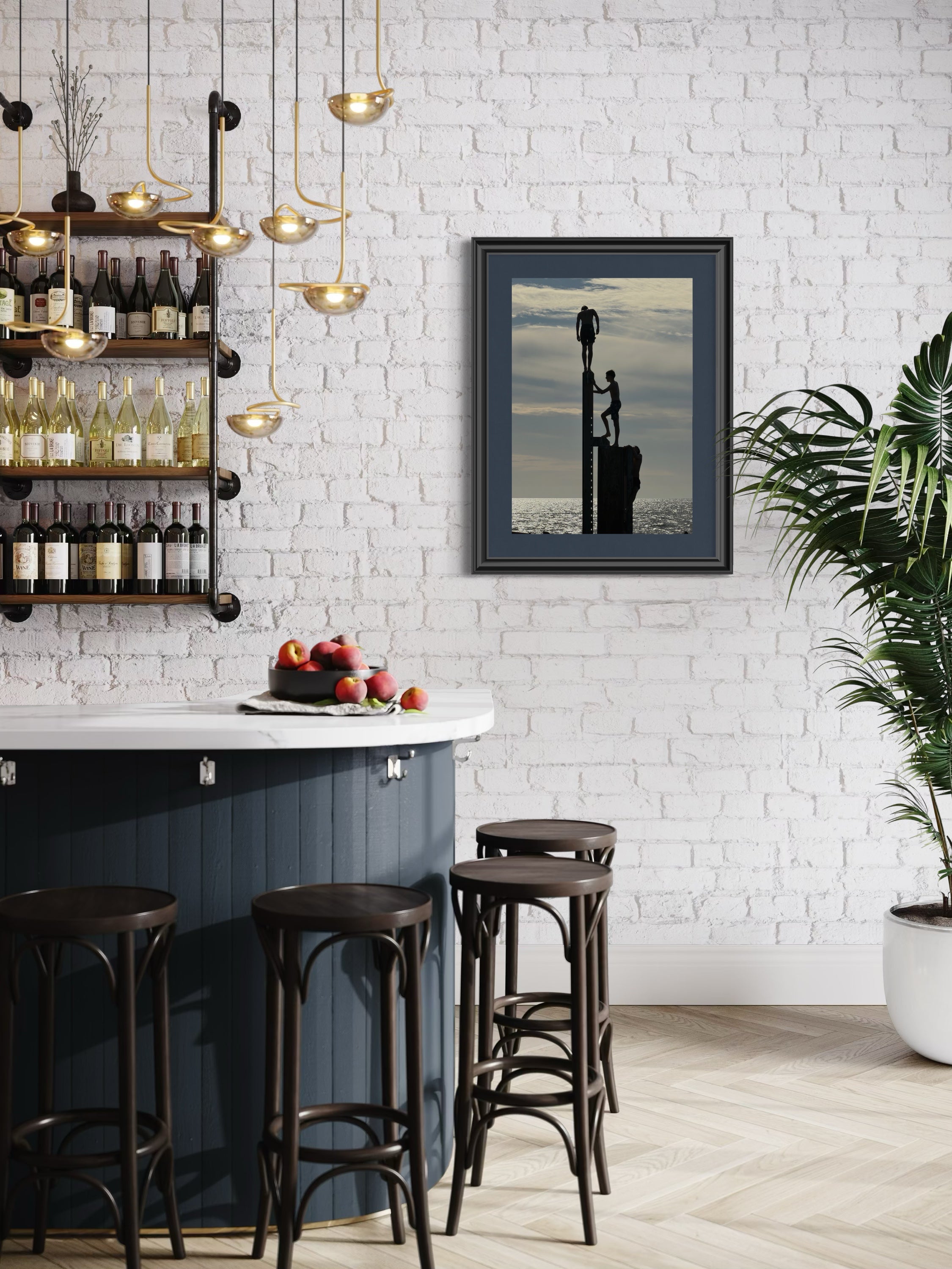 Modern bar area with white brick wall, framed artwork, and bar stools.