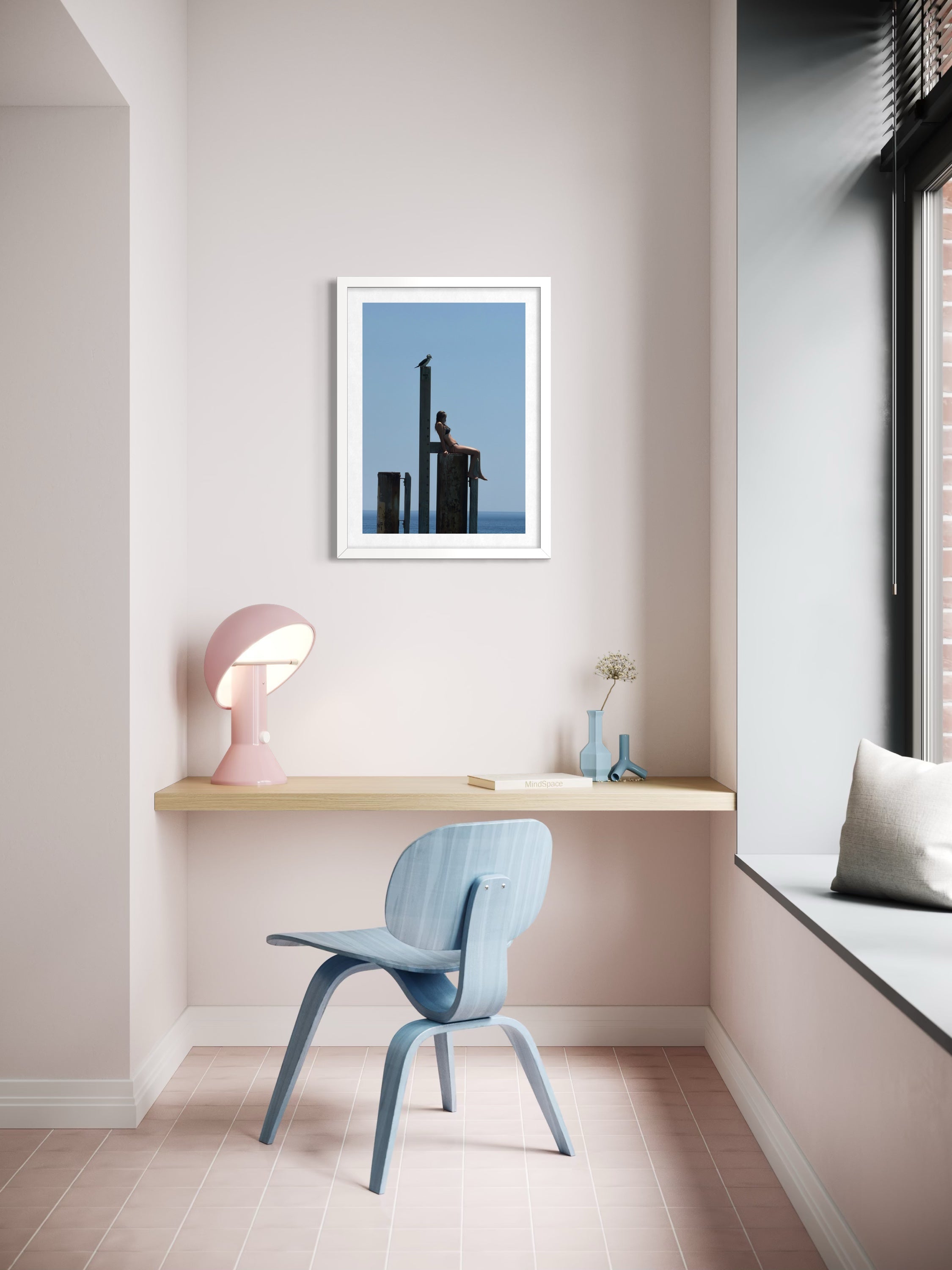 Modern home office with a desk, chair, and wall art.